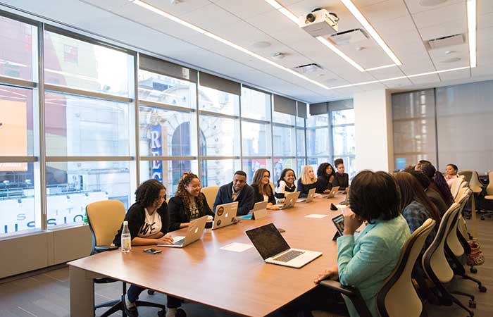 A team sitting at a table in a conference room discussing their scalable reporting solutions